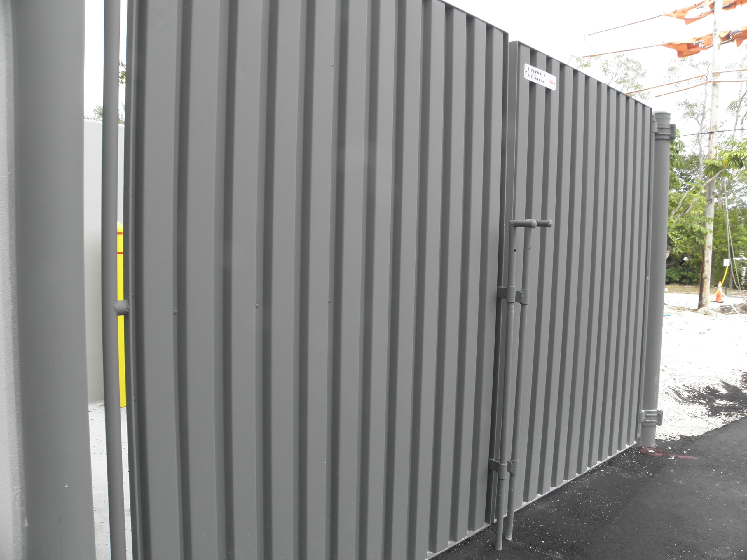 Dumpster area gate and fencing along a building exterior